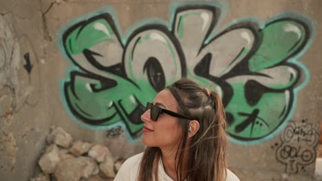 Slow-Motion-Shot-Of-Cool-Woman-Standing-In-Front-Of-Graffity-Design-Art