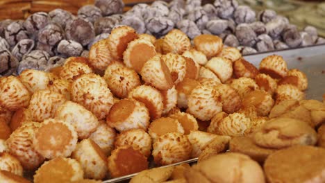 close up view of a variety of baked goods, including coconut cookies, chocolate cookies, and other pastries