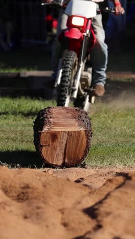 motorbike ascends and descends a log obstacle