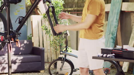 man maintaining dismantled bicycle