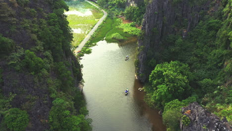 boats travelling on a river through a mountainous