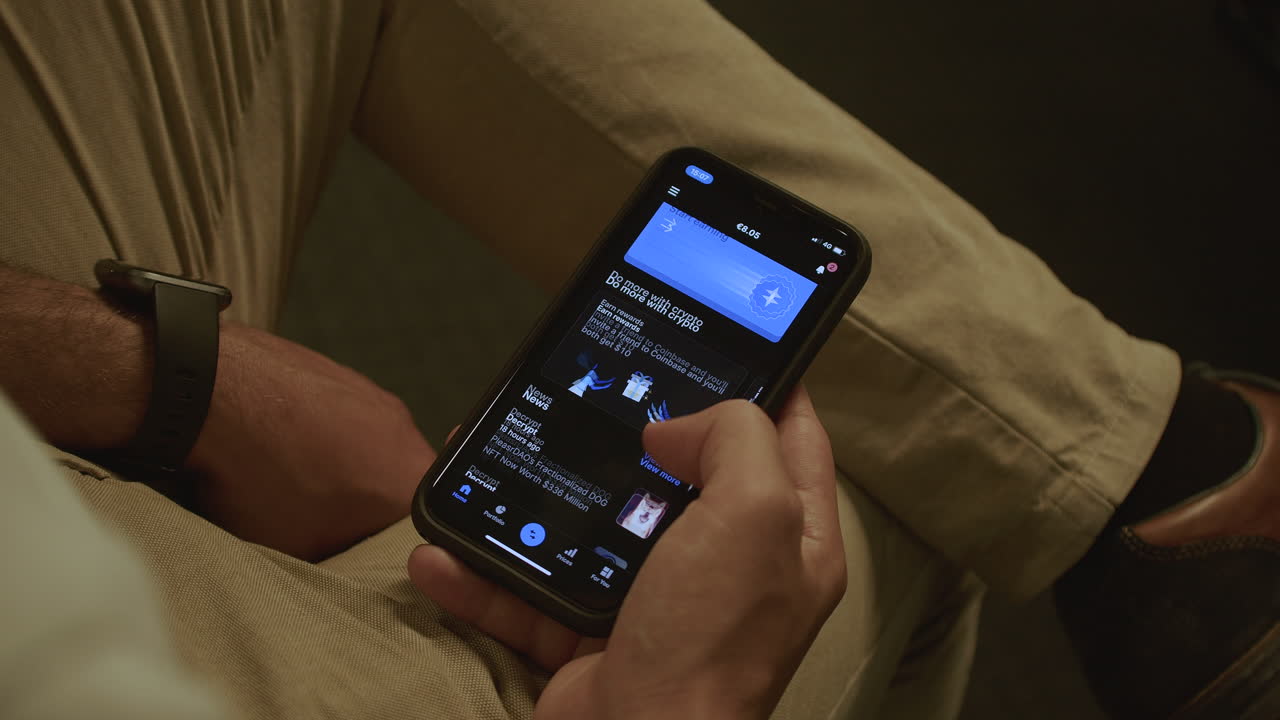 Man sitting down while browsing the Coinbase app viewing Dogecoin