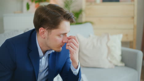 pensive businessman thinking while sitting on sofa