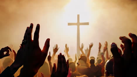 worshippers raising hands in praise at a church gathering during sunset