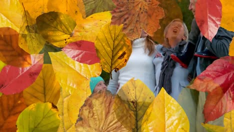 animation of autumn leaves falling over happy caucasian family in park