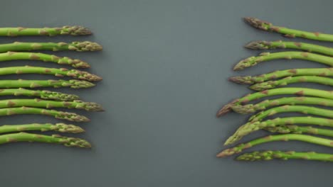 video of fresh asparagus with copy space over grey background