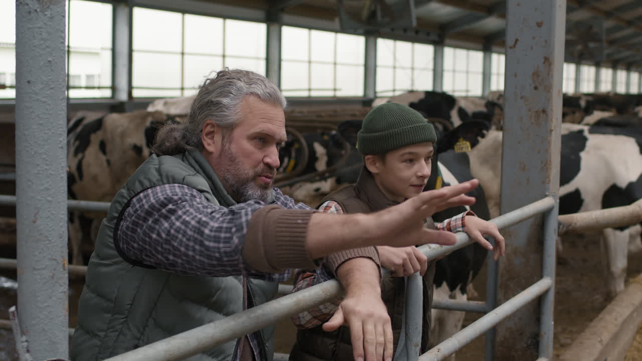 Man and Boy Chatting inside Dairy Farm Facility
