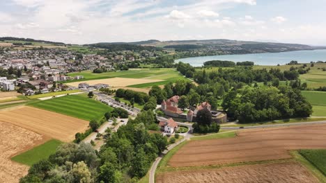 Drone view of Hallwyl Castle near Seengen with surrounding farmland and Hallwilersee in the background