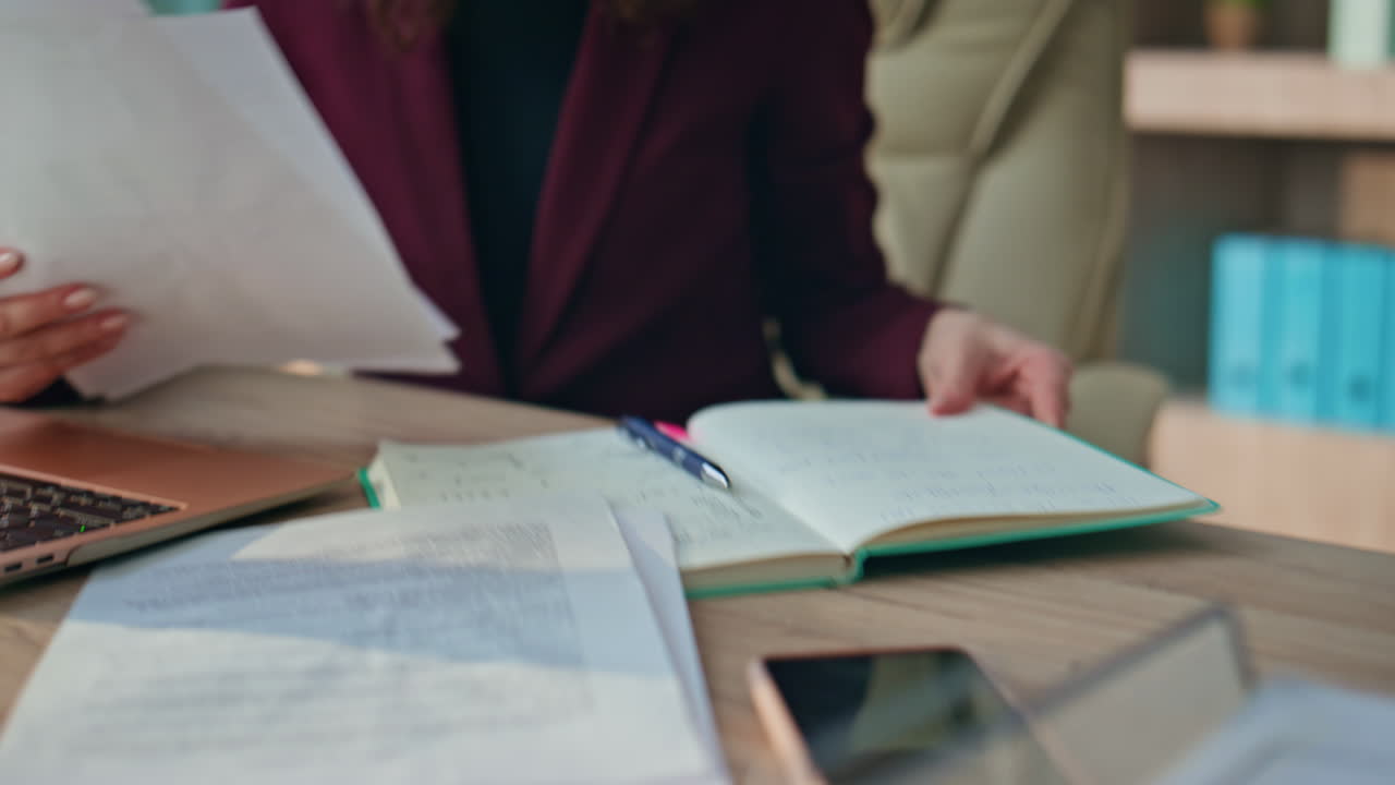 Busy lawyer working desk with papers closeup. Manager hands checking notebook