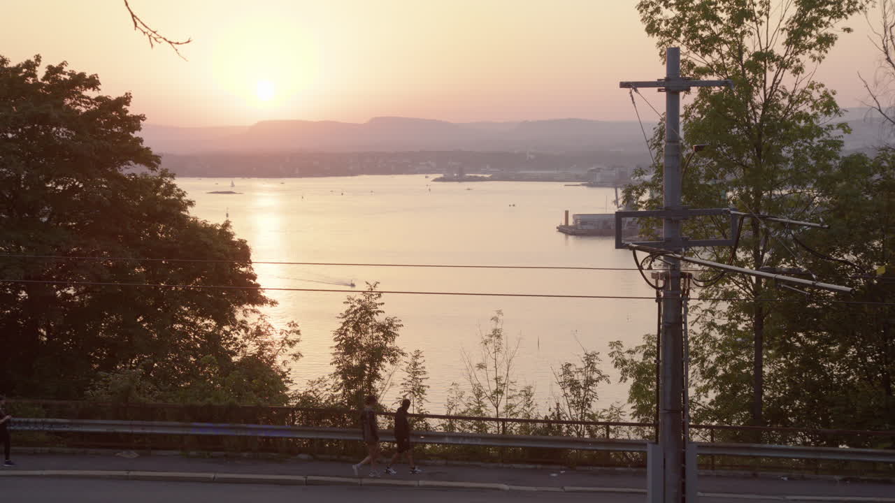 Golden hour sunset view from Kongsveien in Oslo as tram drives uphill