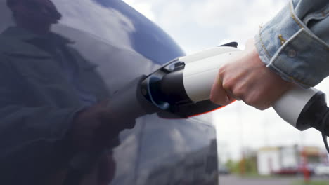 Close-up-view-of-hand-holding-a-plug