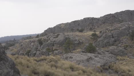 a hispanic hiker on top of mount tlaloc under a cloudy sky in mexico