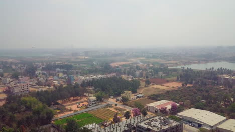moving drone view of bangalore city with kalkere lake at a distance in karnataka, india. 4k.