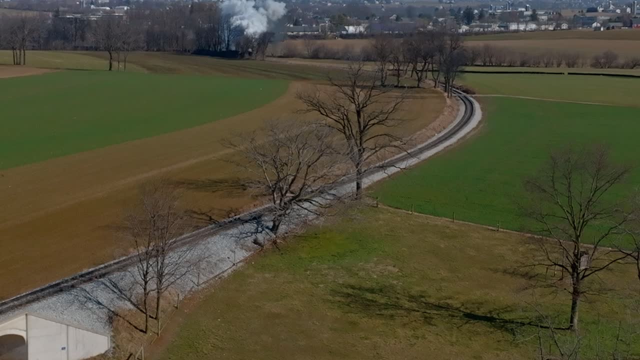 Steam Train Chugging Through Rural Landscape