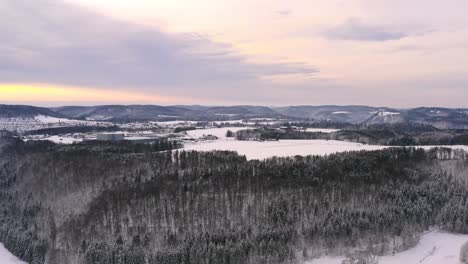 Winter-landscape---Panning-shot-with-the-llok-into-the-sunny,-cloudy-sky-over-a-snowy-landscape