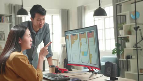 worried unhappy asian male and female mobile application designers arguing and discuss new app features. they work on a personal computer