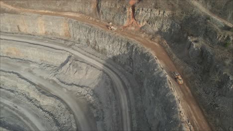 Aerial-footage-of-two-trucks-passing-each-other-in-a-rock-quarry