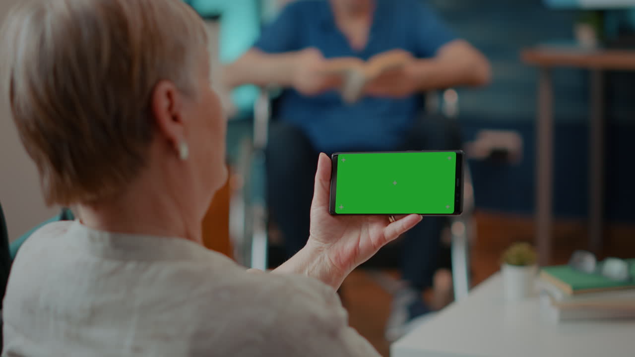 Senior Woman Using Smartphone with Green Screen