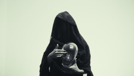 mysterious figure holding a glass skull