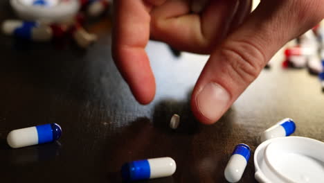 a drug addict pouring out prescription painkillers, narcotics and medicine in a frantic search to get high