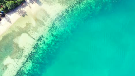 turquoise lagoon with calm clear water and white sand of exotic beach on beautiful shoreline of tropical island in myanmar