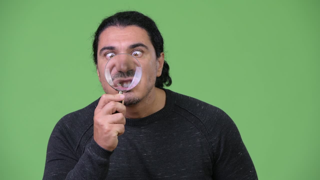 Handsome man with magnifying glass