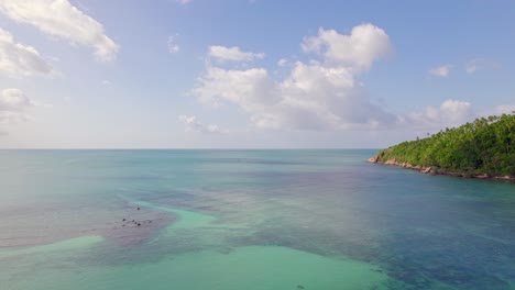 4k-Aerial-Drone-Footage-Orbit-Shot-of-Salad-Beach-on-Koh-Phangan-in-Thailand-with-Fishing-Boats,-Teal-Water,-Coral,-and-Green-Jungles