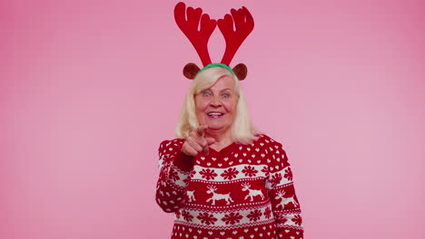 Senior-Christmas-grandmother-woman-smiling-excitedly-pointing-to-camera-beauty-choosing-lucky-winner