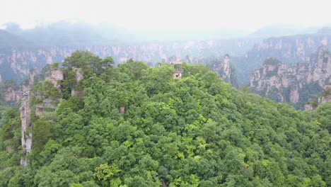 Misty-surreal-atmosphere-at-rock-spire-viewpoint-in-Hunan,-China