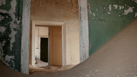 abandoned house buried by sand dunes