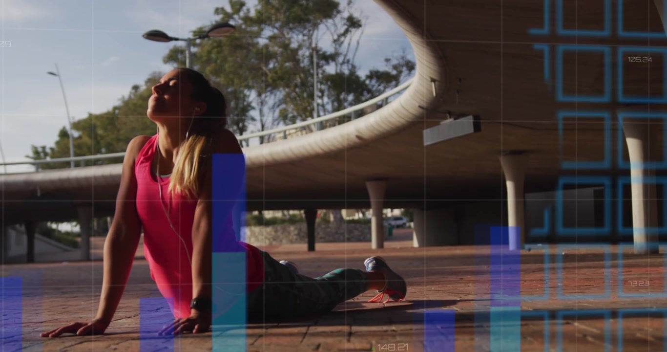 A young woman is stretching during a workout under a bridge