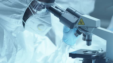 scientist in protective uniform examining contagious blood under lab microscope
