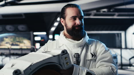 portrait of smiling astronaut holding protection helmet