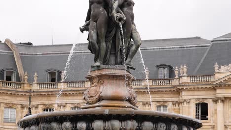 water flows from a detailed sculpture fountain