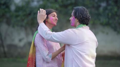 romantic indian couple celebrating holi festival
