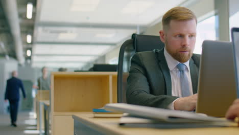 businessman working on laptop at office desk