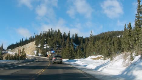 dash cam footage of driving in colorado mountains, behind a snowplow