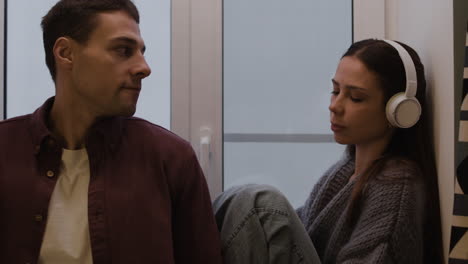 couple talking at a window