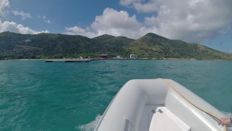 dinghy going to shore on jost van dyke island in the british virgin islands from diamond cay. yachters transportation to bubbly pool and foxy's taboo that was rebuilt after the hurricane
