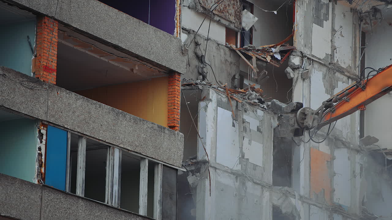 Demolition building by machine. Destruction excavator house demolishing.