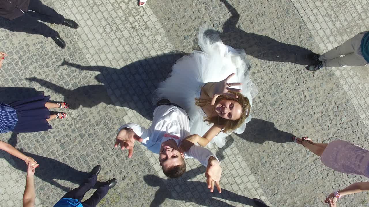 Top View Portrait Of Bride And Groom. Aerial shot of a top view portrait of bride and groom in a park
