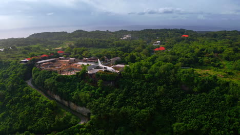 Private-jet-plane-perched-on-jungle-cliff-and-being-repaired,-Bali