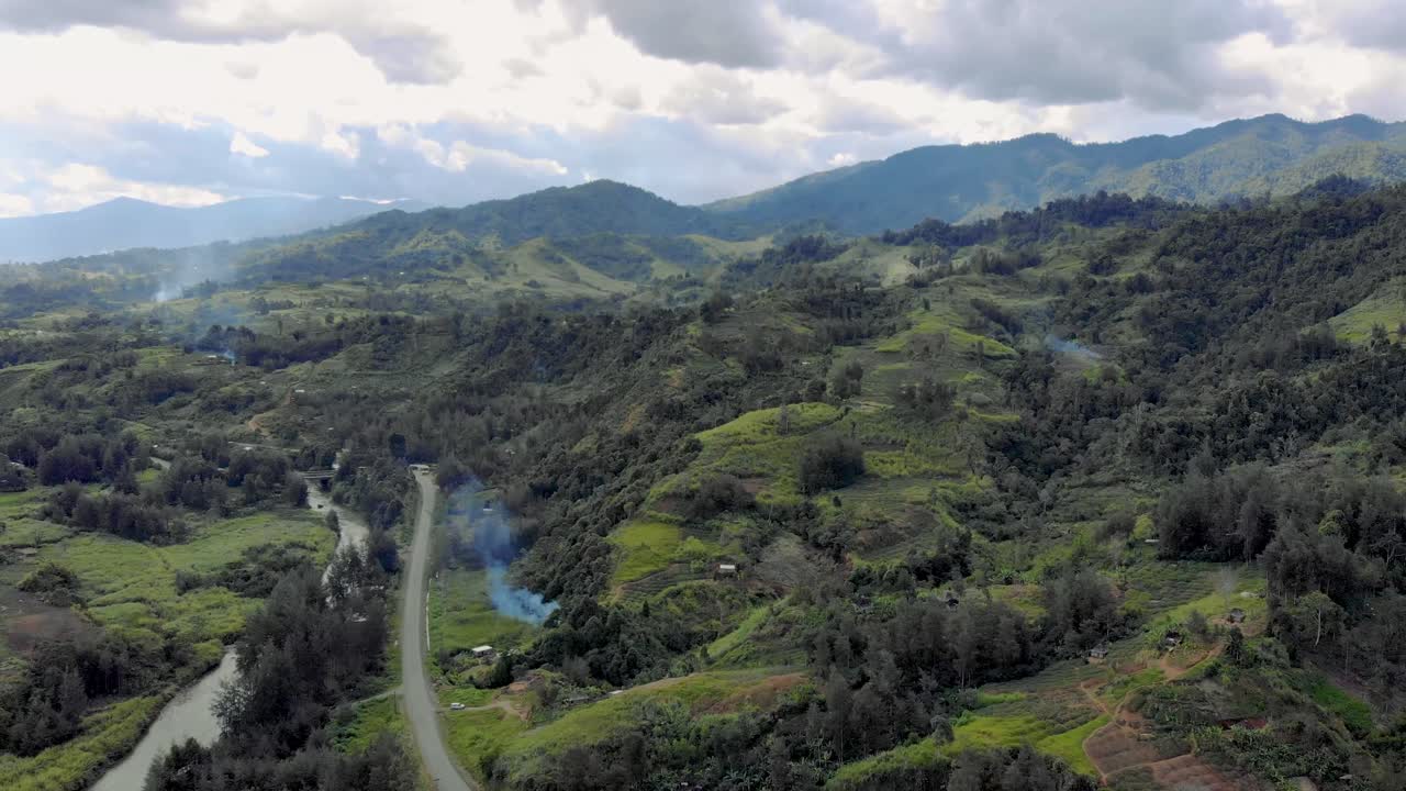 Enga province, Papua New Guinea, aerial flight over rural mountains and road