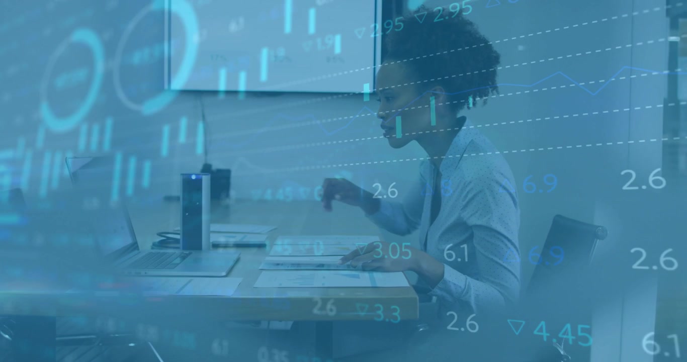 Businesswoman leaning forward studying finance papers animating chart marking key figures on laptop