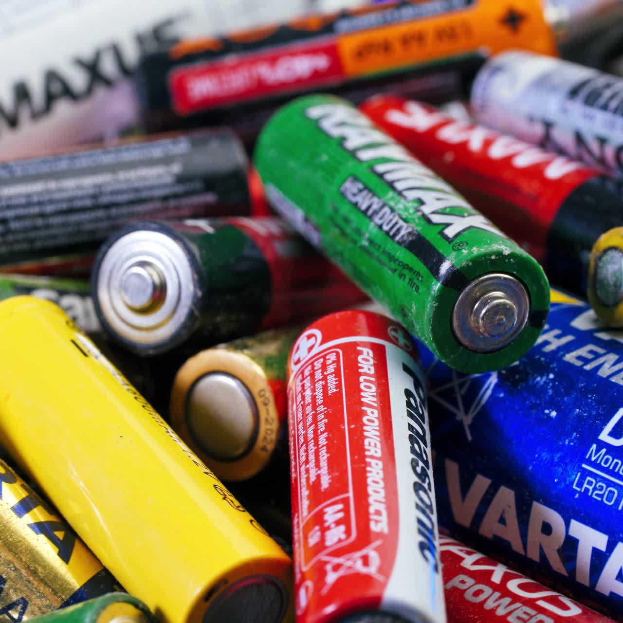 Used batteries from different manufacturers, waste, collection and recycling, high danger for the environment. Batteries background