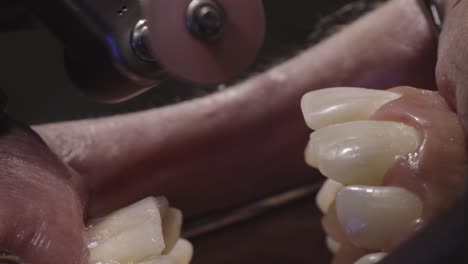 close-up view of a dental technician working on dentures