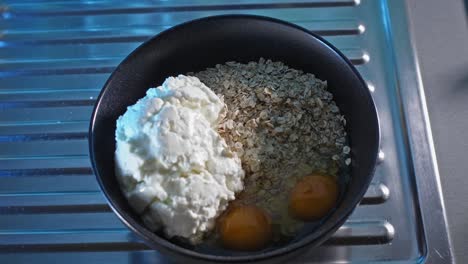 oatmeal and chicken ingredients filling a bowl