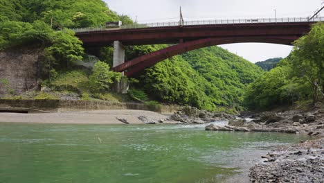 metal bridge over katsura river in kyoto, japan, hozukyo station