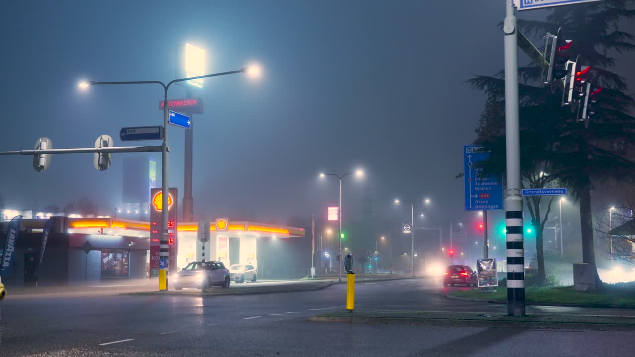 Foggy Night Scene at a Gas Station with Traffic