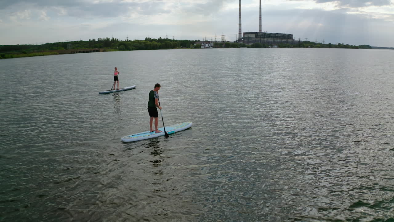 Standup paddle board surfing. People standing firmly on SUP board and paddling